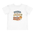 Toddler Tee – “Raised on Jesus & Chicken Nuggets” Cute Faith Kids Shirt